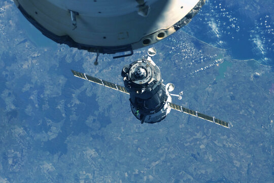 Docking spacecraft in outer space. Elements of this image furnished NASA.