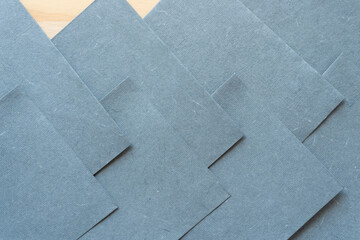 neutral gray paper sheets arranged so that edges are staggered or layered
