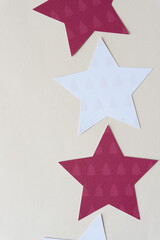 machine-cut white are red scrapbook paper stars with tree patterns on blank paper