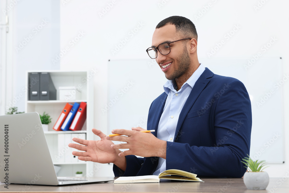 Sticker Happy young intern having online meeting in modern office