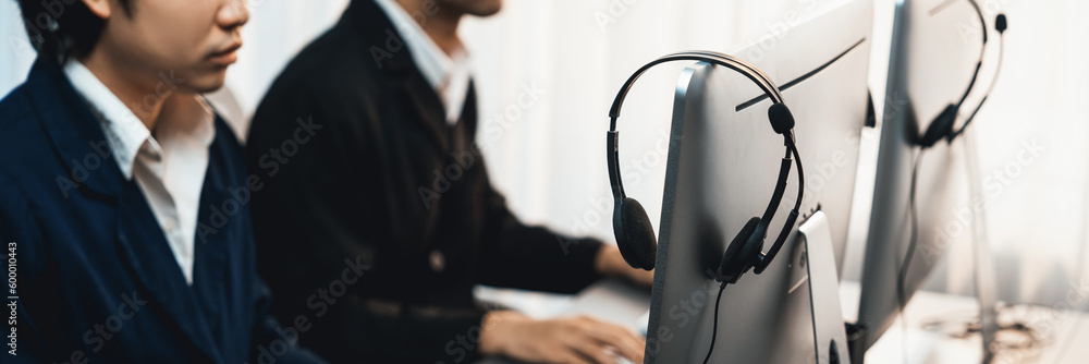 Aufkleber panorama focus headset on call center workspace desk with blur background of operator team or telesa