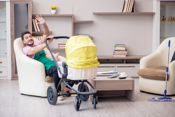 Young male contractor cleaner looking after newborn