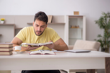 Young male student studying at home
