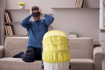 Young male contractor looking after baby at home