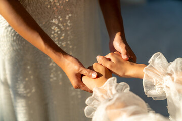 Beautiful Asian woman lesbian couple in white wedding dress holding hands together in wedding...