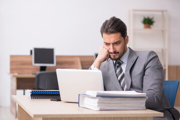 Young male employee working in the office