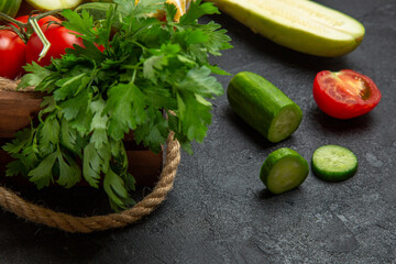 front view fresh vegetables greens squashes cucumbers and tomatoes on grey backgound meal salad vegetable food ripe