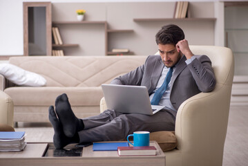 Young male employee working from home