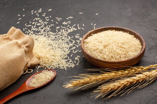front view raw rice inside bag and plate on grey background rice food east cooking raw
