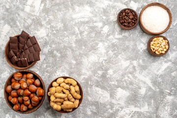 top view chocolate bars with hazelnuts and peanuts on white desk peanut nut snack food