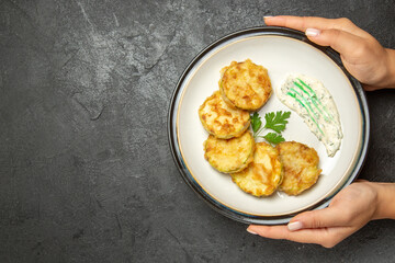 top view cooked squashes slices inside plate on a dark grey background vegetable meal food dinner squash