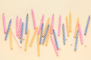 Colorful birthday candles on beige background