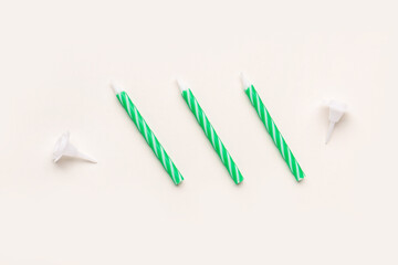 Green birthday candles on white background
