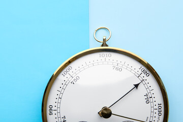 Aneroid barometer on blue background