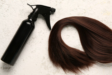 Brown hair with spray on grunge background