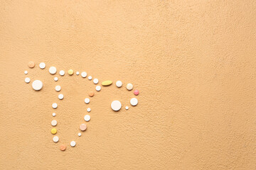 Fototapeta na wymiar Uterus made of pills on beige background. Hormones concept