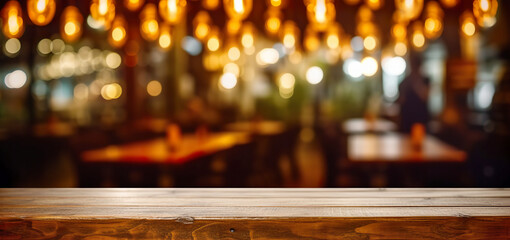 Fototapeta na wymiar Wooden table in front of abstract blurred restaurant lights background