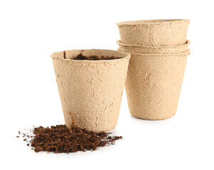 Peat pots with soil on white background