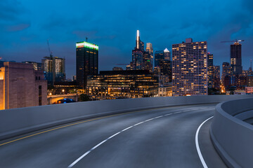 Fototapeta premium Empty urban asphalt road exterior with city buildings background. New modern highway concrete construction. Concept way to success. Transportation logistic industry fast delivery. Philadelphia. USA.