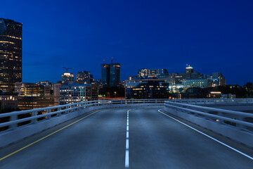 Empty urban asphalt road exterior with city buildings background. New modern highway concrete construction. Concept way to success. Transportation logistic industry fast delivery. Seattle. USA.