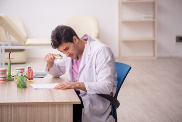 Young male dentist working in the clinic