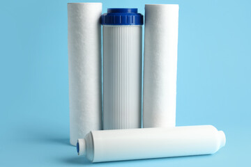 New water filter cartridges on blue background