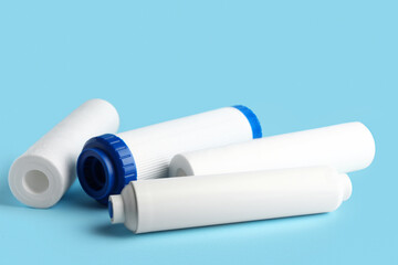 New water filter cartridges on blue background