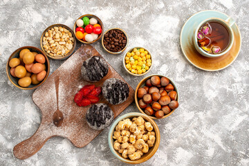 top view delicious chocolate balls cakes with nuts and tea on white background cake biscuit sugar cookie sweet tea