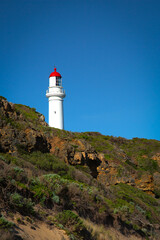 Fototapeta na wymiar Split point lighthouse on a beach at Alreys in Australia