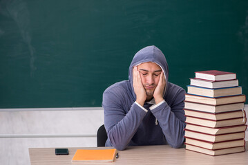 Young male student sitting in the classroom