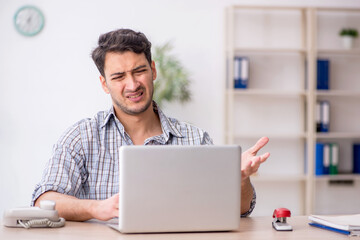 Young male employee working in the office