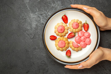 top view delicious little cookies with pink cream inside plate on grey desk cookie biscuit sugar tea cake sweet
