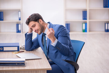 Young male employee working in the office