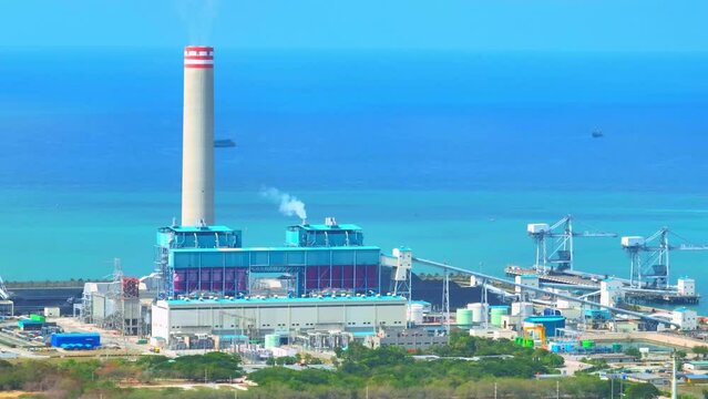 Coal-fired power plants use the burning of coal to generate electricity. During this process, a large amount of smoke, ash, and other pollutants are released into the air. Electric energy concept. 4K
