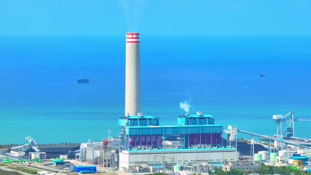 In recent years, there has been a push to reduce the emissions from coal-fired power plants by implementing pollution control technologies, such as scrubbers and catalytic converters. Aerial view. 4K
