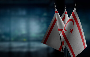 Small flags of the Northern Cyprus on an abstract blurry background
