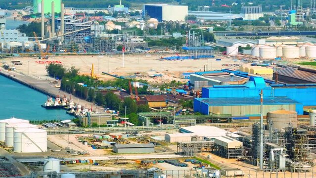 A refinery or petrochemical complex would likely appear as a vast and intricate industrial landscape, consisting of multiple processing units, storage tanks, pipelines, and other infrastructure. Drone