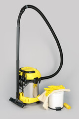 Vacuum cleaner with bin on grey background