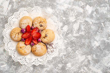 Fototapeta na wymiar top view delicious sugar cookies from sand dough with strawberries on the white background fruit cookie biscuit sweet sugar