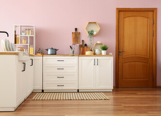 Interior of stylish kitchen with white counters