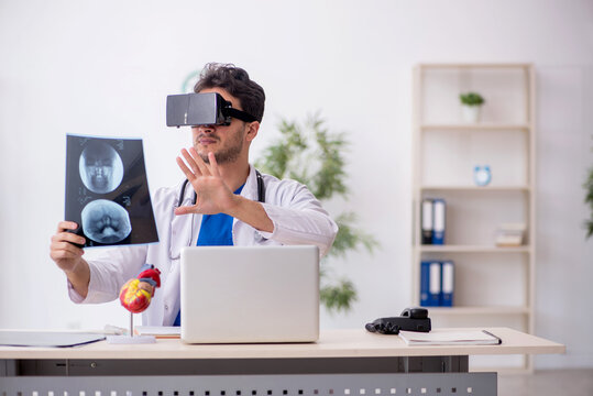 Young male doctor enjoying virtual glasses in the clinic