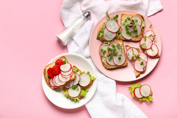 Plates with delicious radish bruschettas on pink background