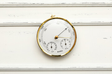 Aneroid barometer on white wooden background