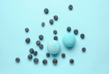 Bath bombs with blueberry on blue background