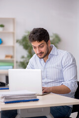 Young male employee working in the office