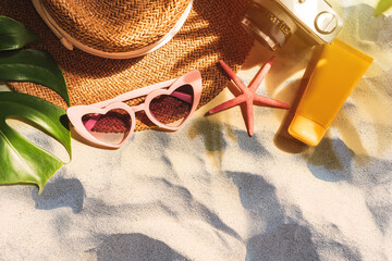 Travel summer accessories and items with shadow of tropical leaves on sand background with copy space, Vacation planning concept