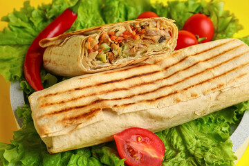 Tasty shawarma with lettuce and tomatoes, closeup