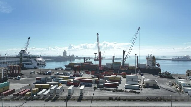 Landside aerial view of cargo vessel loaded by cranes in Table Bay harbor, Cape Town, South Africa