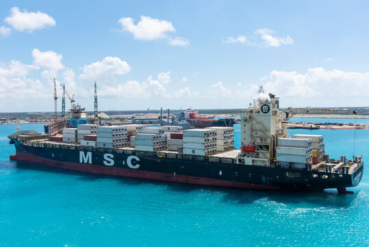 Freeport, Bahamas - April 15, 2023: MSC owned cargo ship departing from the container terminal, Bahamas Islands. 
