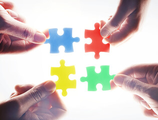 Hands, puzzle and teamwork in group, problem solving or together for support, glow or color by...
